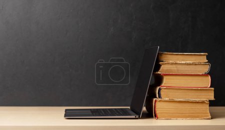 Photo for Laptop and stack of books. With space for your text. Learn and work concept - Royalty Free Image