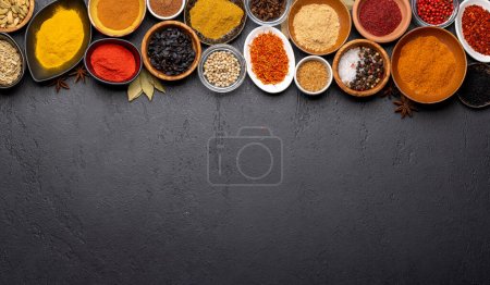 Foto de Various spices in bowls on stone table. With copy space for your menu or recipe - Imagen libre de derechos