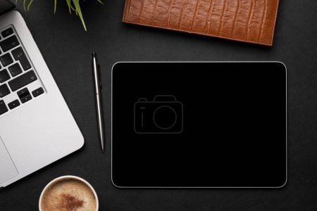 Photo for Office desk table with tablet, laptop computer, cup of coffee and supplies. Top view with copy space. Flat lay - Royalty Free Image