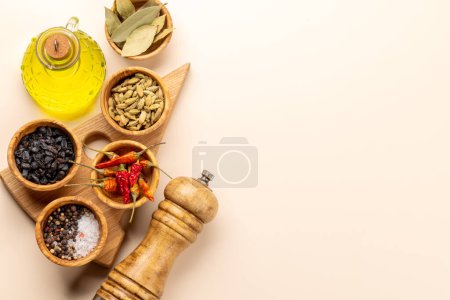 Téléchargez les photos : Various dried spices in small bowls on beige table. Flat lay with copy space - en image libre de droit