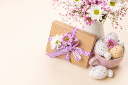 Photo for Gift box, Easter eggs and flowers bouquet with space for your greetings - Royalty Free Image