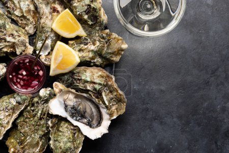 Photo for Fresh oysters with sauce and lemons. With glass of sparkling wine. Flat lay with copy space - Royalty Free Image
