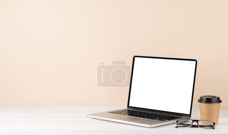 Photo for Laptop with blank screen for your message, app or web and coffee cup. Computer with white display and copy space - Royalty Free Image