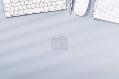 Photo for Top view business office desk with keyboard and office supplies. Flat lay workspace with sunny light and copy space - Royalty Free Image