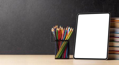 Photo for Tablet with colorful pencils and stack of books. With blank screen for your text or app - Royalty Free Image