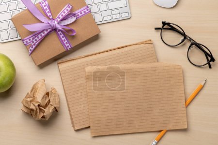 Photo for Desk with a gift, notepad and keyboard, top view and space for note - Royalty Free Image
