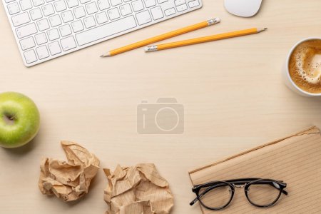 Photo for Top view of blank notepad, keyboard, apple and crumpled papers on desk, depicting unsuccessful attempts at writing - Royalty Free Image