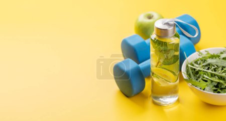 Photo for Healthy lifestyle, sport and diet concept. Dumbbells and healthy food. With space for your text - Royalty Free Image