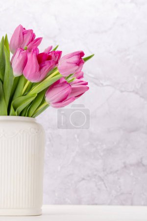Photo for Fresh pink tulip flowers bouquet. On white wooden table with copy space - Royalty Free Image