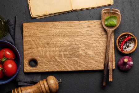 Photo for Top-down view of a kitchen table with ingredients, utensils, and cutting board with copy space, perfect for creating a mockup for recipes, menus of your meal - Royalty Free Image