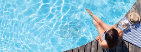 Téléchargez les photos : Femme sur terrasse en bois près de la piscine. Vacances d'été - en image libre de droit