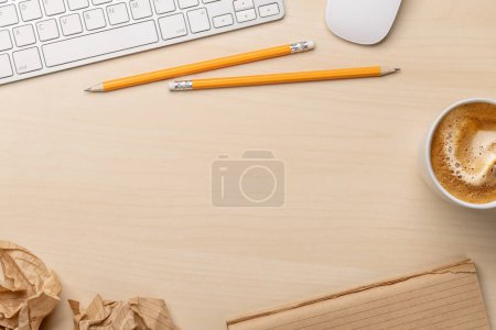 Photo for Top view of blank notepad, keyboard, coffee and crumpled papers on desk, depicting unsuccessful attempts at writing - Royalty Free Image