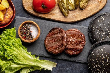 Photo for Homemade beef burgers cooking and ingredients. Flat lay - Royalty Free Image