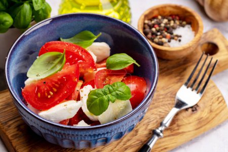 Photo for Caprese salad with ripe tomatoes, mozzarella cheese and garden basil - Royalty Free Image