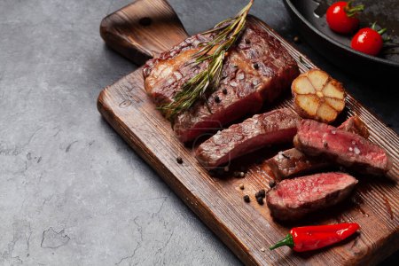 Photo for Grilled ribeye beef steak with herbs and spices. With copy space - Royalty Free Image