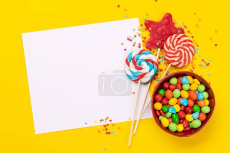 Candy sweets and blank greeting card for your greetings. Flat lay