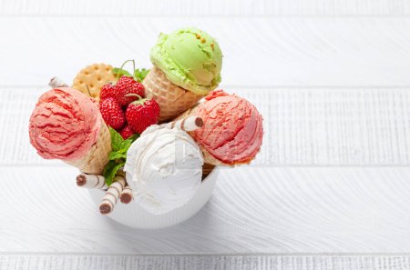 Photo for Various ice cream in waffle cones. Strawberry, pistachio and vanilla icecream. Flat lay with copy space - Royalty Free Image