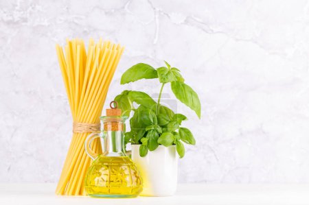Photo for Ingredients for cooking. Italian cuisine. Pasta, olive oil, basil. With copy space - Royalty Free Image