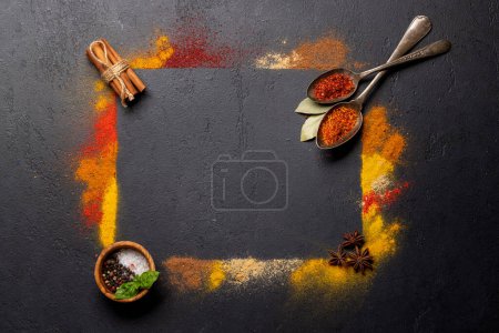 Foto de Various spices on stone table. Frame with copy space for your menu or recipe - Imagen libre de derechos
