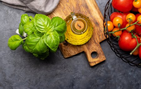 Photo for Ingredients for cooking. Italian cuisine. Tomatoes, basil and olive oil. Flat lay with copy space - Royalty Free Image