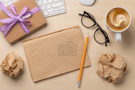 Photo for Desk with a gift, notepad and keyboard, top view and space for note - Royalty Free Image