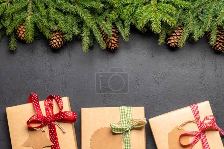 Photo for Xmas fir tree branch, Christmas gift boxes and space for greetings text. Flat lay - Royalty Free Image