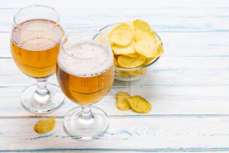 Photo for A tempting snack of beer and chips with copy space - Royalty Free Image