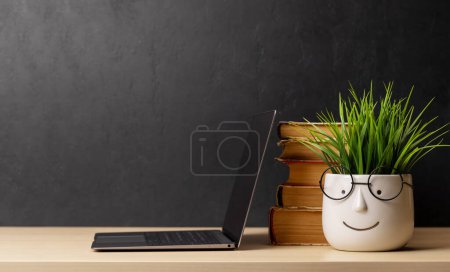 Photo for Laptop and stack of old books. With space for your text. Learn and work concept - Royalty Free Image
