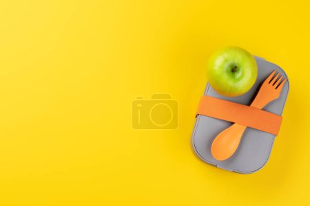Photo for School lunch box on yellow background. Education and nutrition. Flat lay with blank space - Royalty Free Image