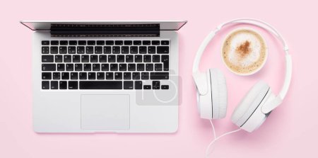 Photo for Laptop, headphones and coffee cup on pink background. Flat lay - Royalty Free Image