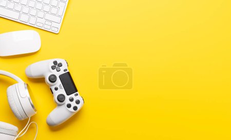 Photo for Gaming gear and tech accessories on a yellow background, perfect for gaming and tech-related themes. Flat lay with copy space - Royalty Free Image