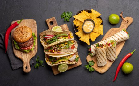 Photo for Mexican food featuring tacos, burritos, nachos, burgers and more. Flat lay - Royalty Free Image