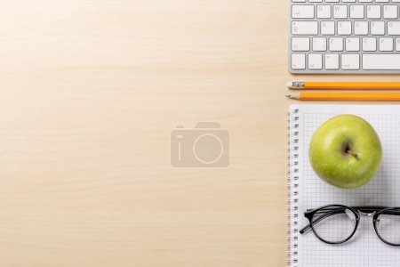 Photo for Top view of keyboard, notebook, glasses, pencils, apple and empty space - Royalty Free Image