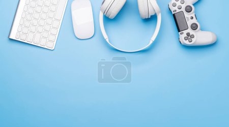 Photo for Gaming gear and tech accessories on a blue background, perfect for gaming and tech-related themes. Flat lay with copy space - Royalty Free Image