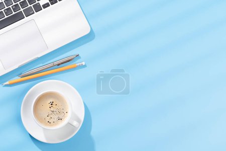 Photo for Top view business office desk with laptop, office supplies and coffee. Flat lay workspace with sunny light and copy space - Royalty Free Image