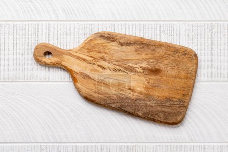 Photo for Wooden cutting board on kitchen table. Flat lay with copy space - Royalty Free Image