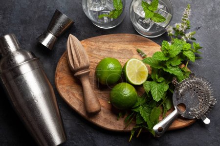 Photo for Mojito cocktail ingredients and drinks utensils. On stone table flat lay - Royalty Free Image