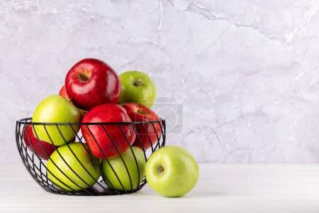 Photo for Red and green garden apples in basket. With copy space - Royalty Free Image