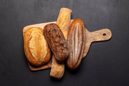 Photo for Fresh baked bread on cutting board. Flat lay with - Royalty Free Image