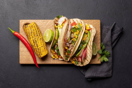 Photo for Mexican food featuring tacos and grilled vegetables. Flat lay - Royalty Free Image