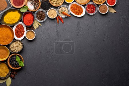Photo for Various spices in bowls on stone table. With copy space for your menu or recipe - Royalty Free Image