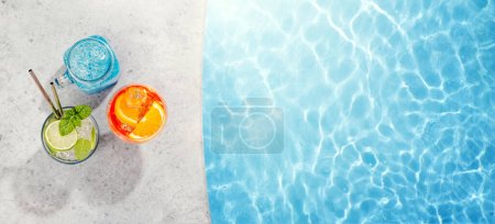 Photo for Refreshing cocktails by the pool on a sunny day, the perfect summer vacation. View from above with space for your text - Royalty Free Image