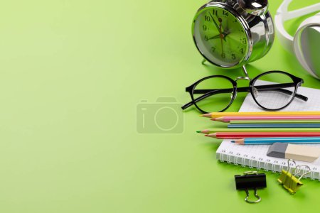 Téléchargez les photos : School supplies and stationery on green background. Flat lay with blank space - en image libre de droit