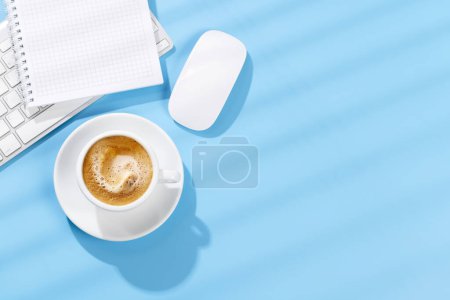 Photo for Top view business office desk with keyboard, office supplies and coffee. Flat lay workspace with sunny light and copy space - Royalty Free Image