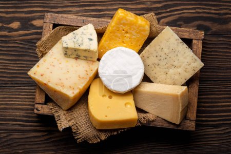 Photo for Various cheese in wooden box. Flat lay - Royalty Free Image