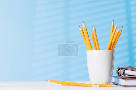 Photo for An organized arrangement of pencils and notepads on an office desk, offering ample copy space for your creative ideas or text - Royalty Free Image