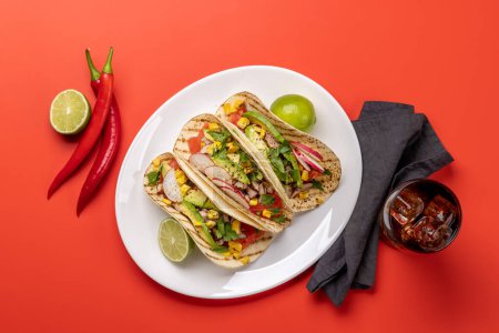 Photo for Mexican food featuring tacos with meat and grilled vegetables. Flat lay over red - Royalty Free Image