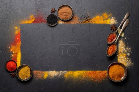 Photo for Various spices on stone table. Frame with copy space for your menu or recipe - Royalty Free Image