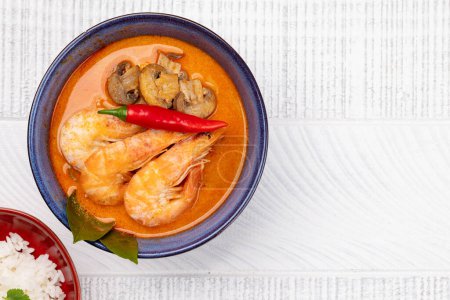 Photo for Thai Tom Yum Soup with seafood and bowl of rice. Flat lay with copy space - Royalty Free Image