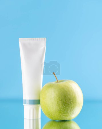 Photo for A clean and refreshing image featuring toothpaste tube and apple, promoting oral hygiene and a bright smile - Royalty Free Image